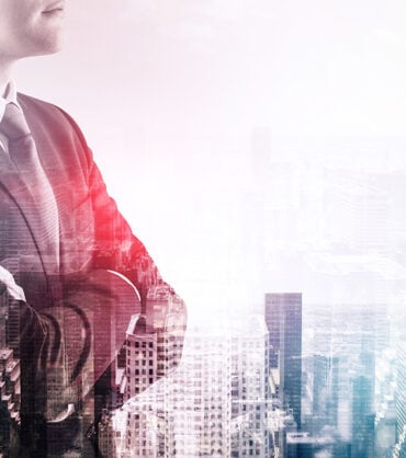 Side view of unrecognizable businessman standing with crossed arms over modern cityscape background. Toned image double exposure mock up