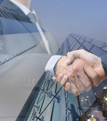 Double exposure of business handshake of two businessmen and the city, business agreement concept