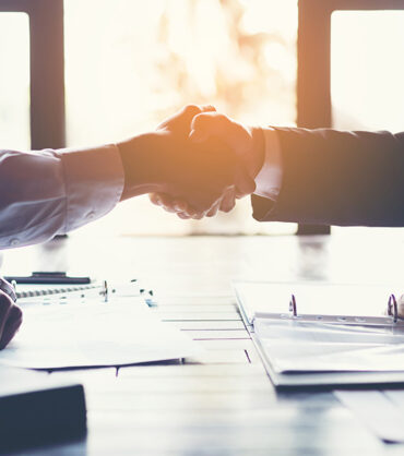 business partners handshaking after business success negotiation at meeting room
