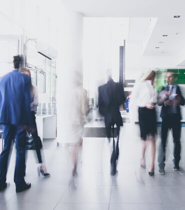 businesspeople walking in the corridor of an business center, pronounced motion blur