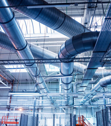 Air conditioning of buildings. Background of ventilation pipes. Laying of engineering networks. Industrial background