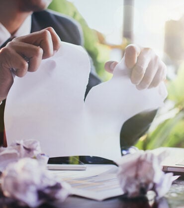 stressed businessman tearing papers