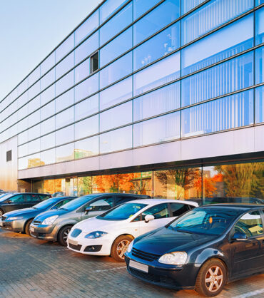 Сars parked on the street at the Office corporate building.