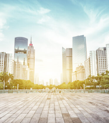 empty, modern square and skyscrapers under sunbeam