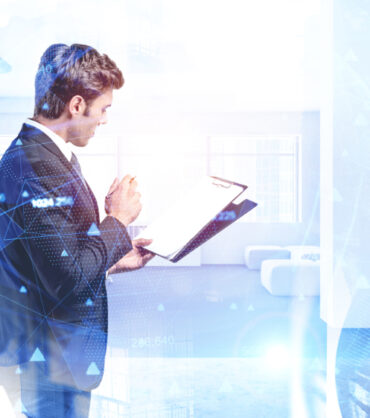 Portrait of young businessman making notes in clipboard in modern office with double exposure of abstract cityscape and blurry network hologram. Toned image