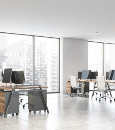 Corner of panoramic open space office with white walls, tiled floor and rows of wooden computer tables with white chairs. 3d rendering