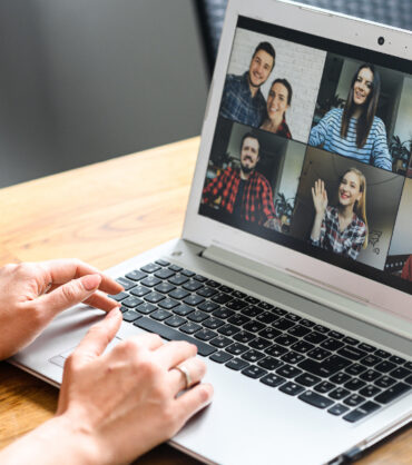 Video call, zoom. Icons of a group of people on laptop screen, app for video online communication. Female hands on the keyboard