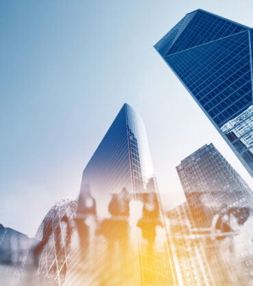 Silhouettes of people walking in the street near skyscrapers and modern office buildings in Paris business district. Multiple exposure blurred image. Economy, finances, business concept illustration.