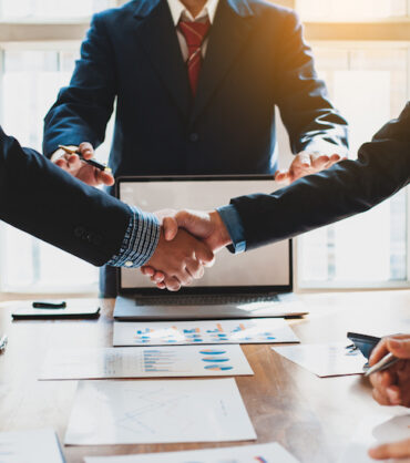 Business people shake hands with business partnership at a meeting. The concept of mediation.
