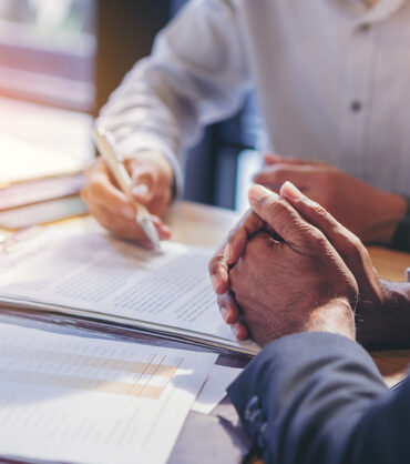 businessman reading documents at meeting, business partner considering contract terms before signing checking legal contract law conditions